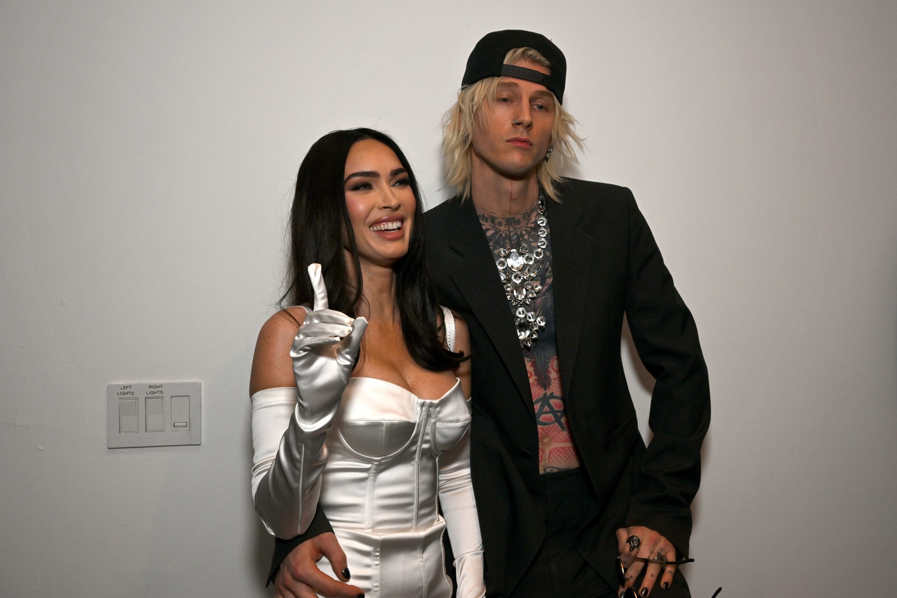 Megan smiling with MGK