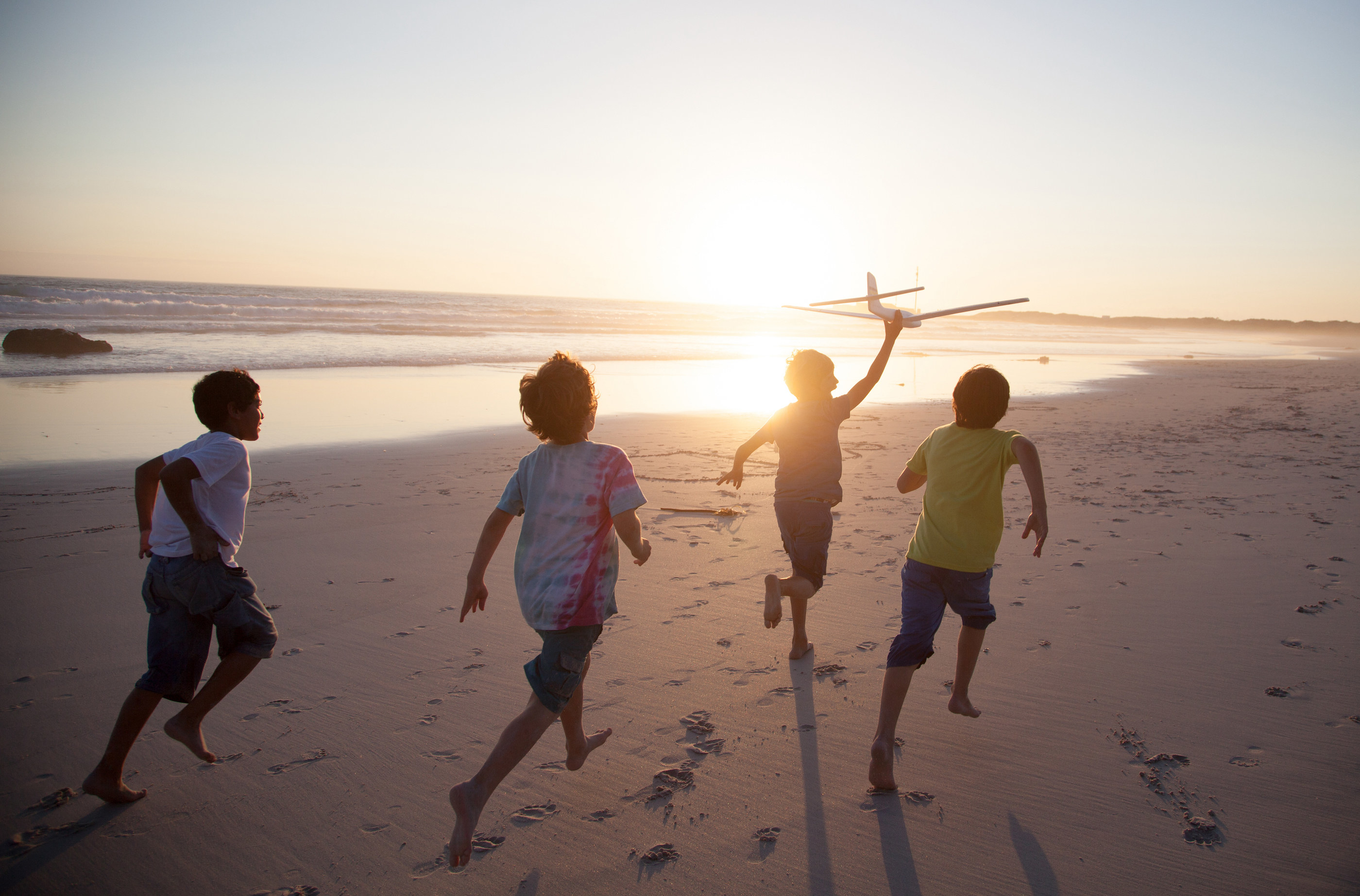 Children running along the beach