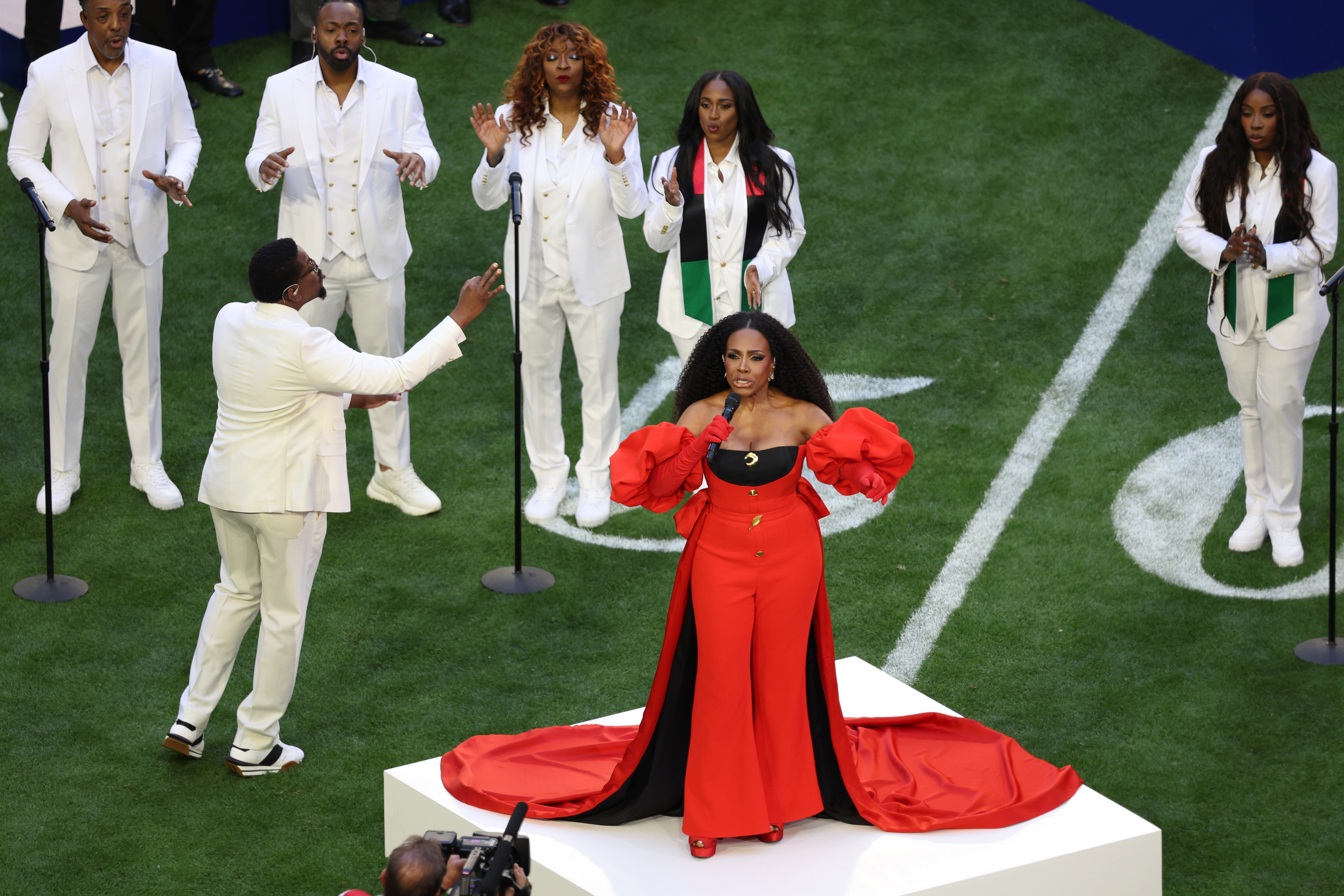 Ralph singing on a podium on the football field