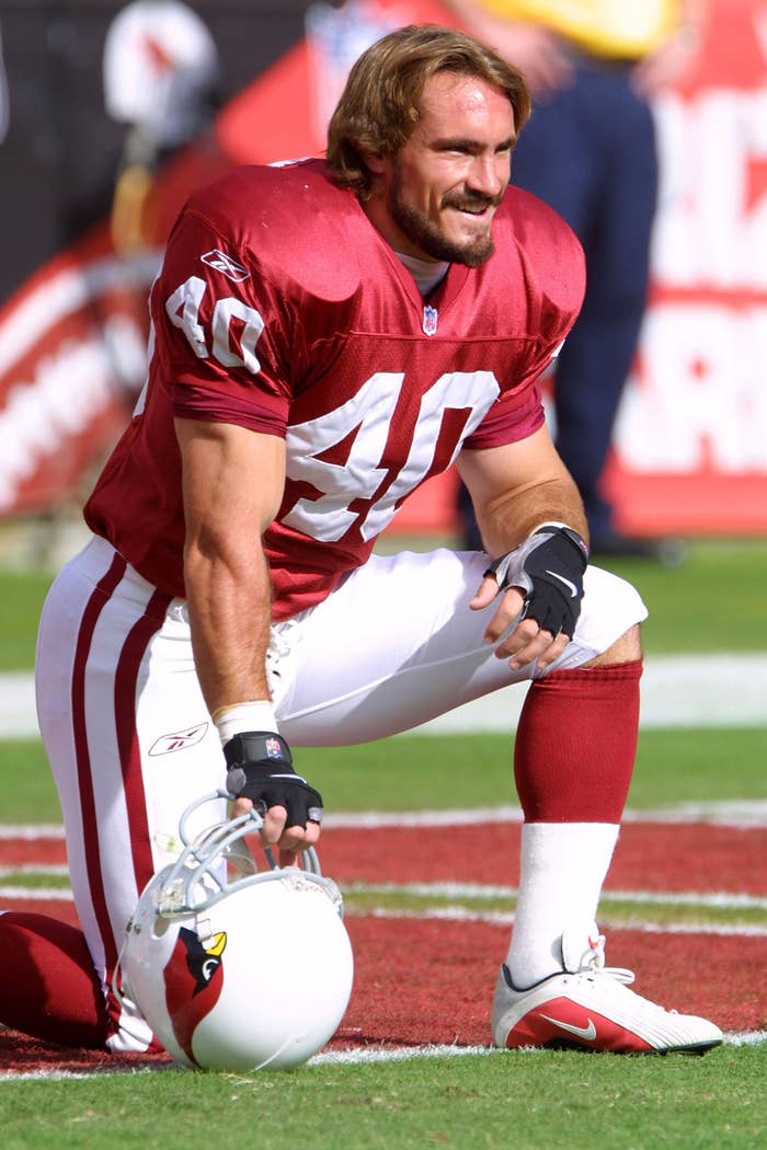 Pat Tillman kneels on a football field