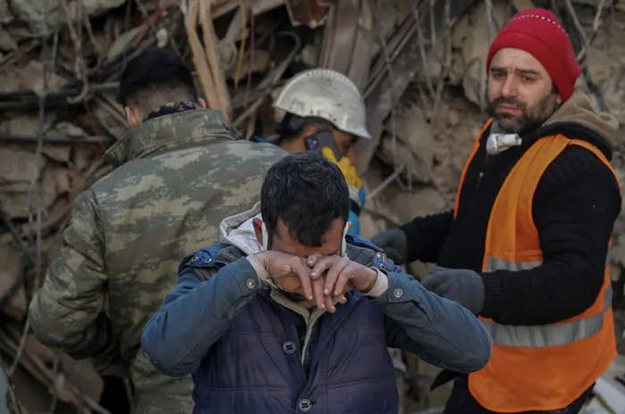 a man crying at a earthquake rescue site in Turkey