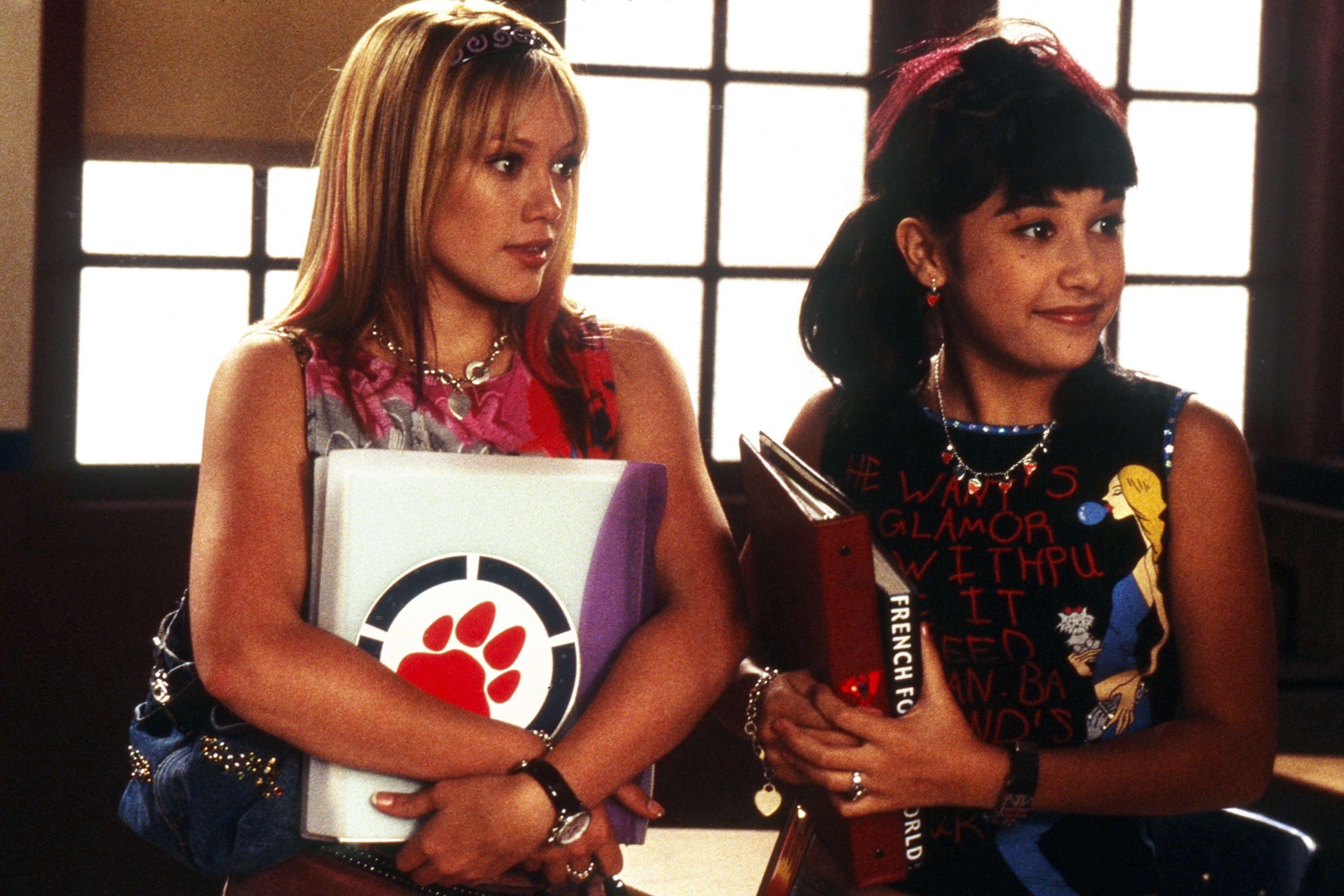 Hilary Duff and Lalaine hold books in a hallway