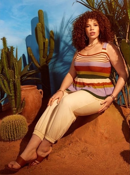 Model wearing tan pants with colorful striped top with tan sandals
