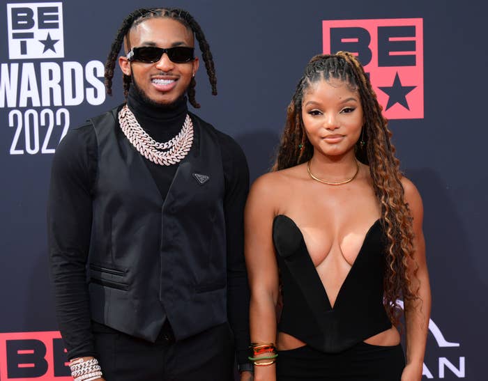 A close-up of Halle and DDG smiling on the red carpet