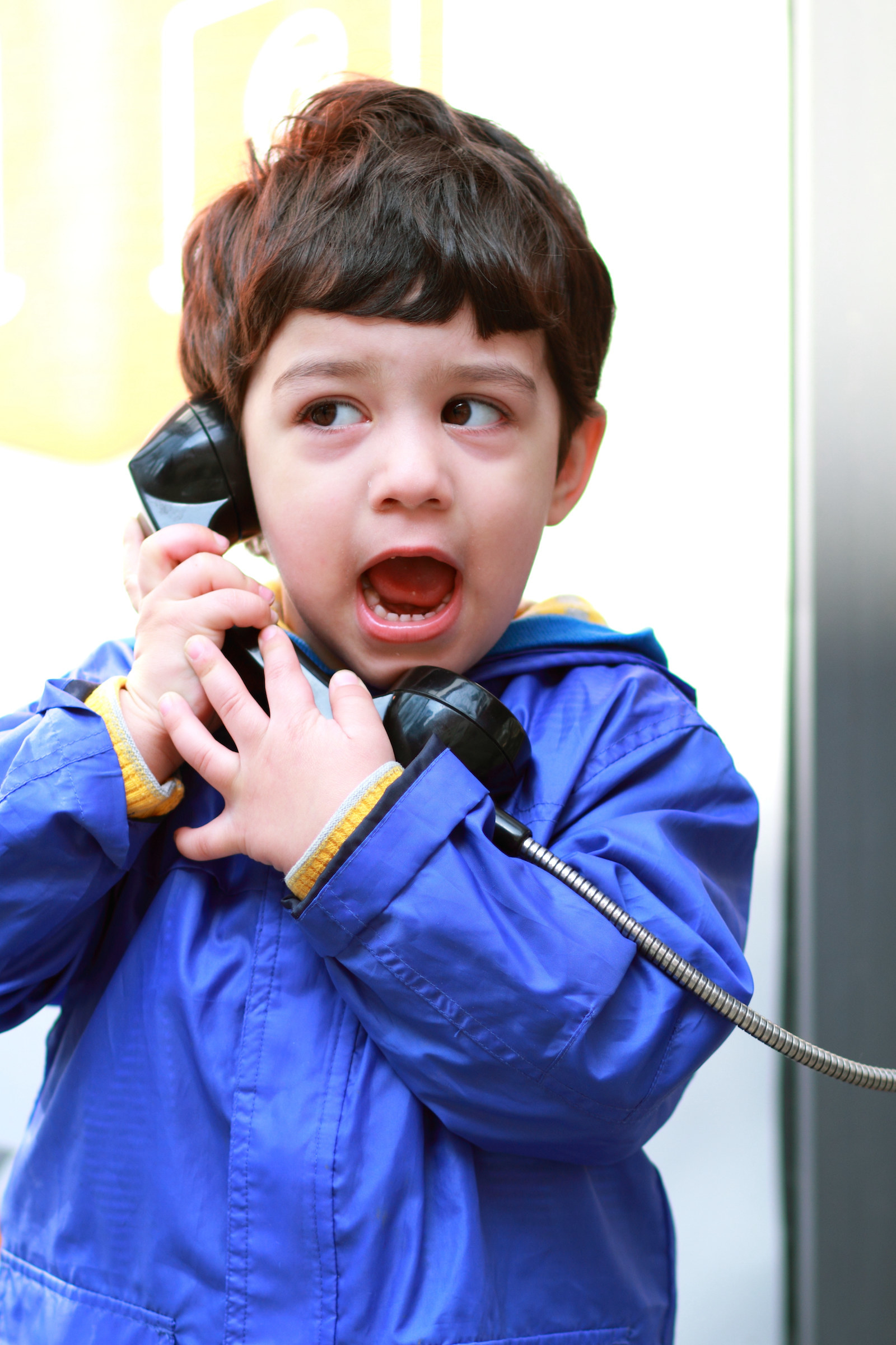 Young boy on a corded phone