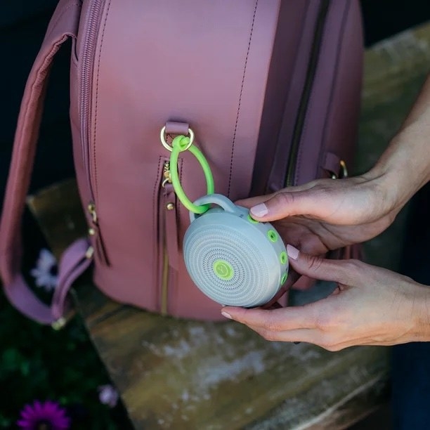 a person shows off the portable white noise machine