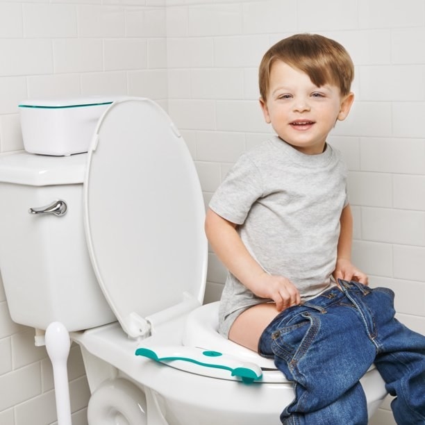 a child sits on the travel potty seat