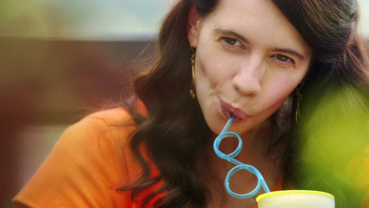 Kalki sips a drink out of a spiral straw