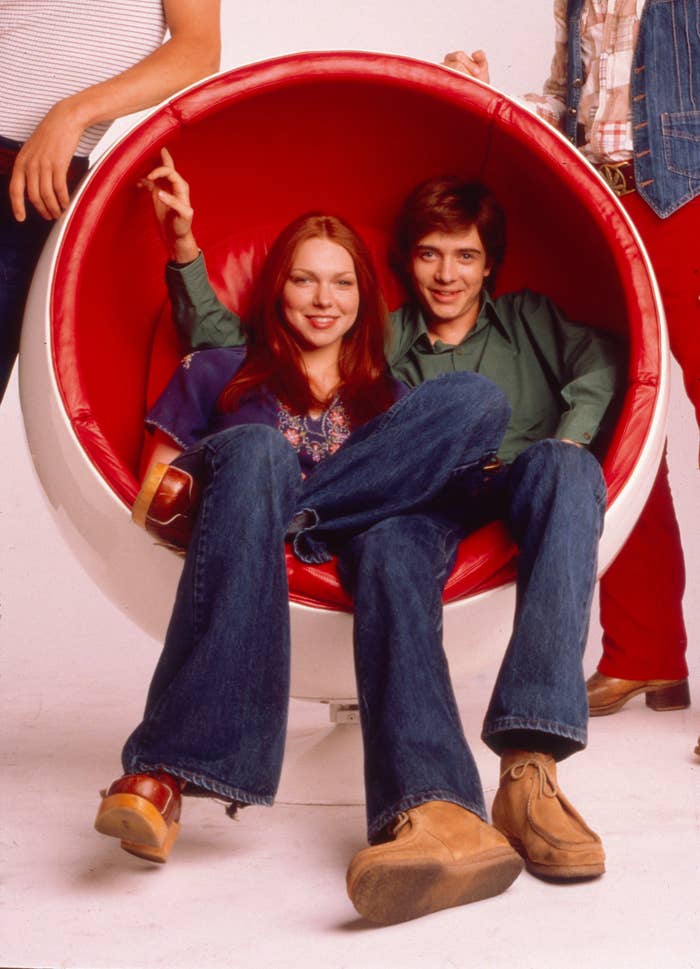 Eric and Donna sit in an egg chair together