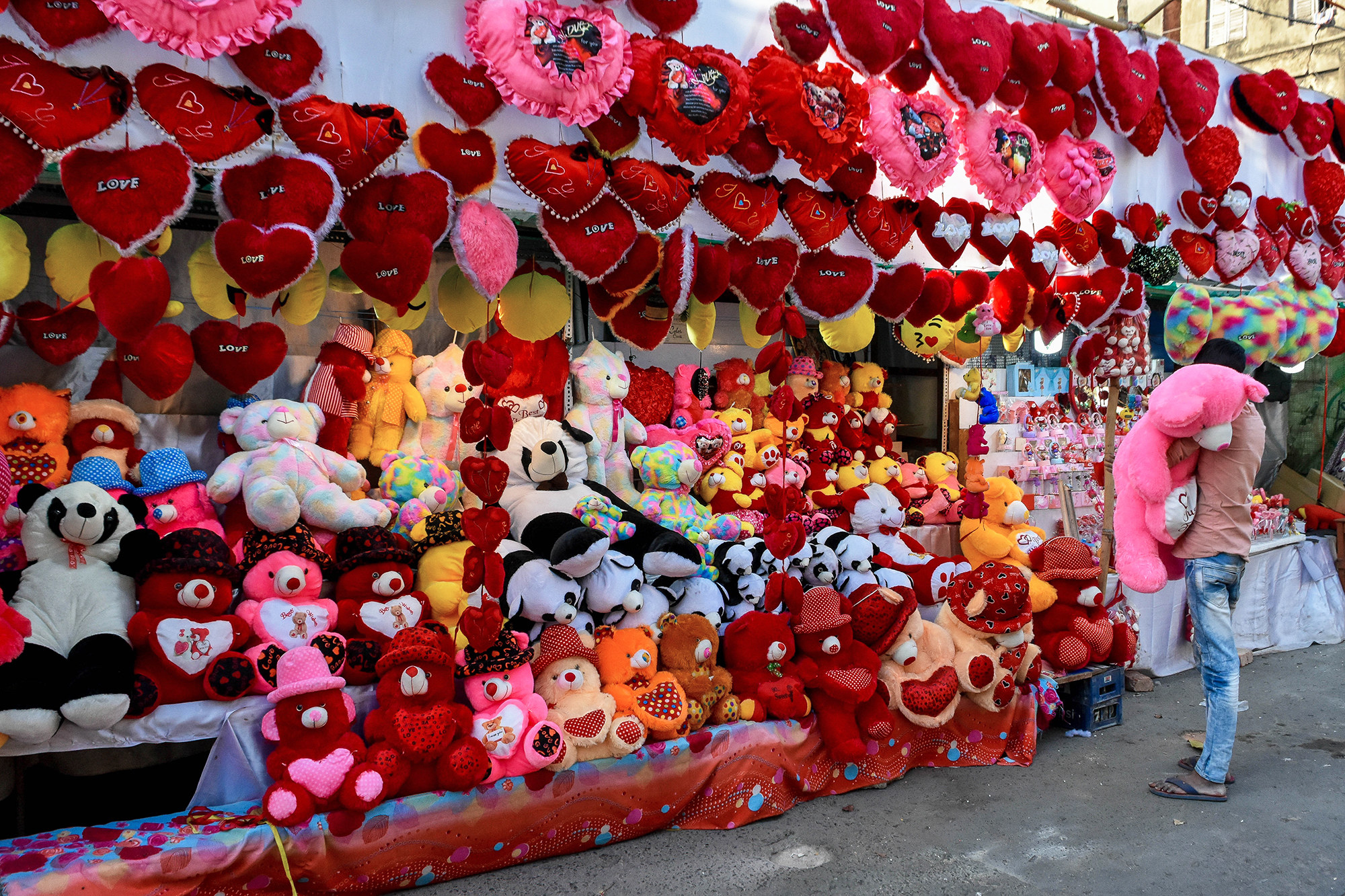 a gigantic outdoor stand filled with valentines day bears and other stuffed animals