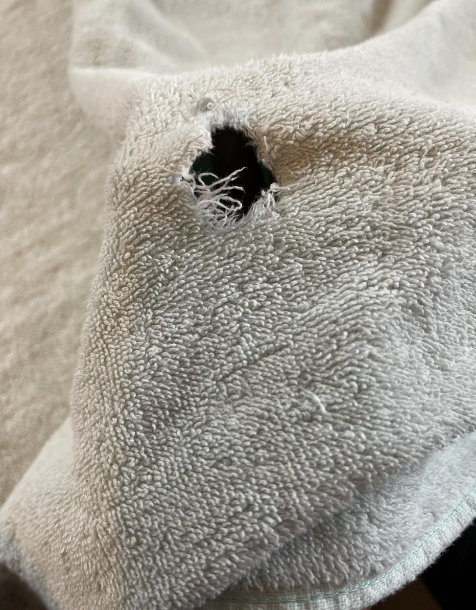 A hole has been cut right in the middle of a towel