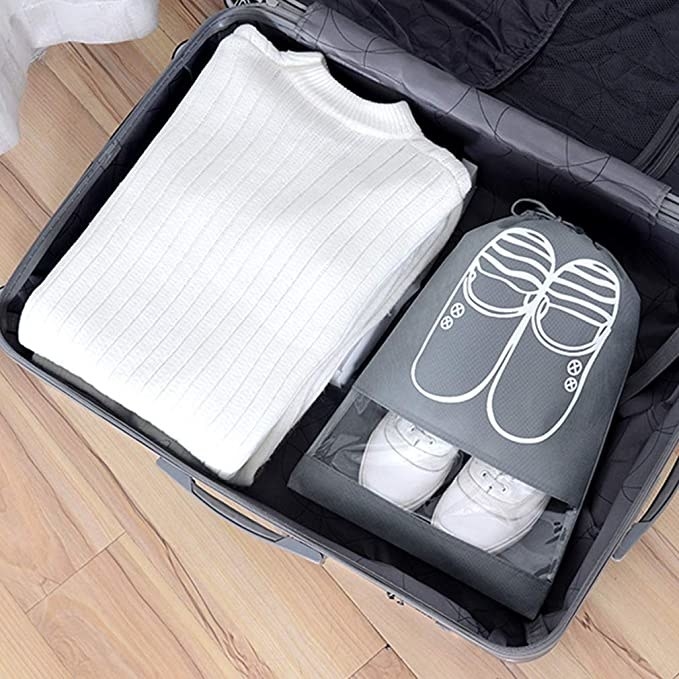 drawstring shoe bag packed inside of suitcase