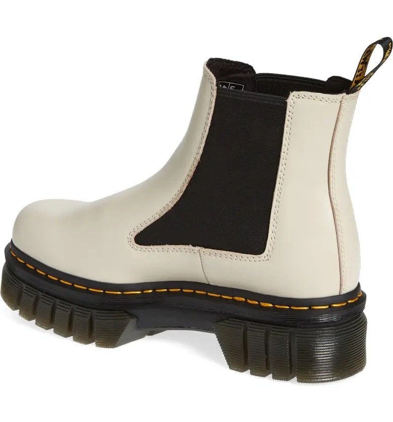 A white and black pair of boots