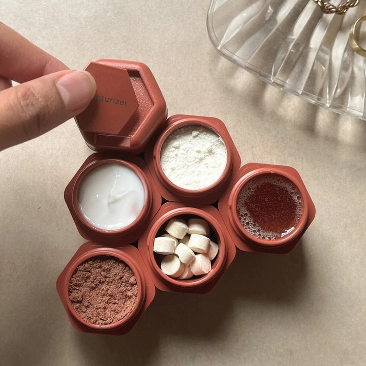 a group of six red containers attached together