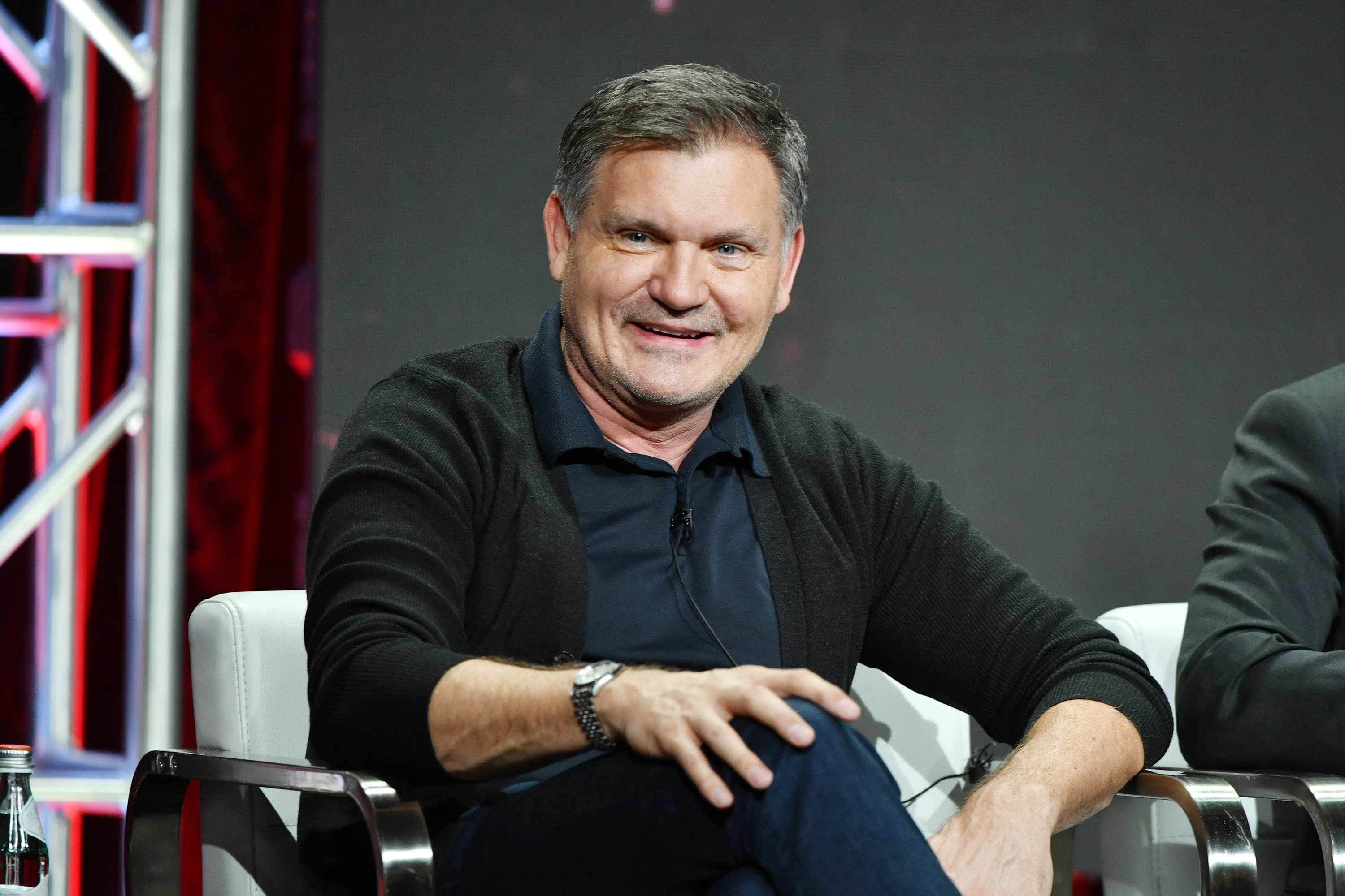 kevin williamson sitting and smiling toward the camera