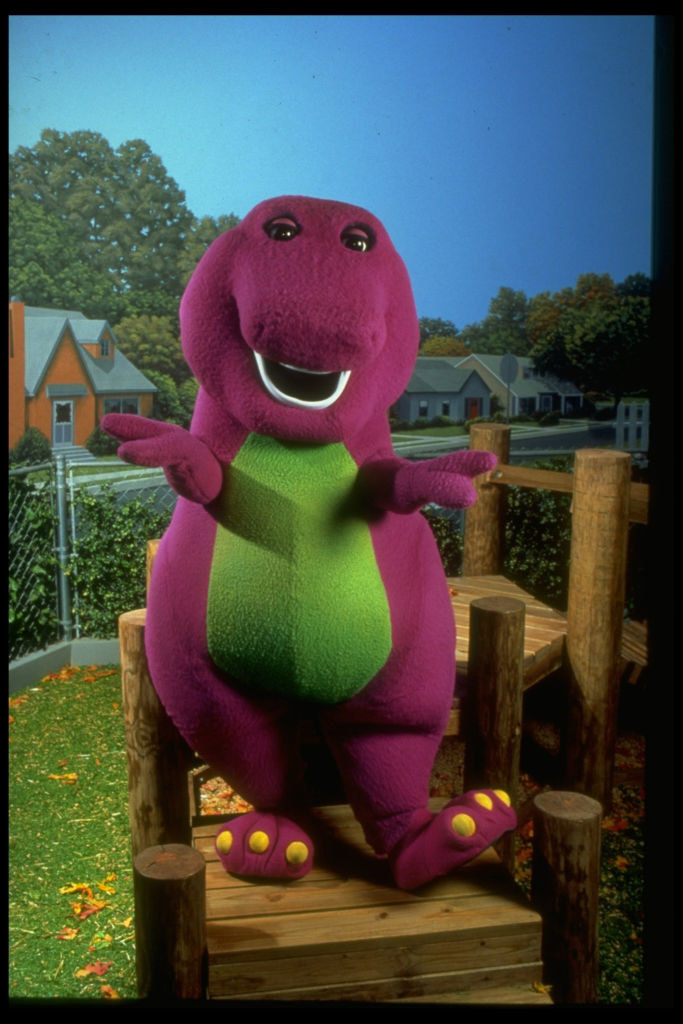Barney standing on a playground apparatus