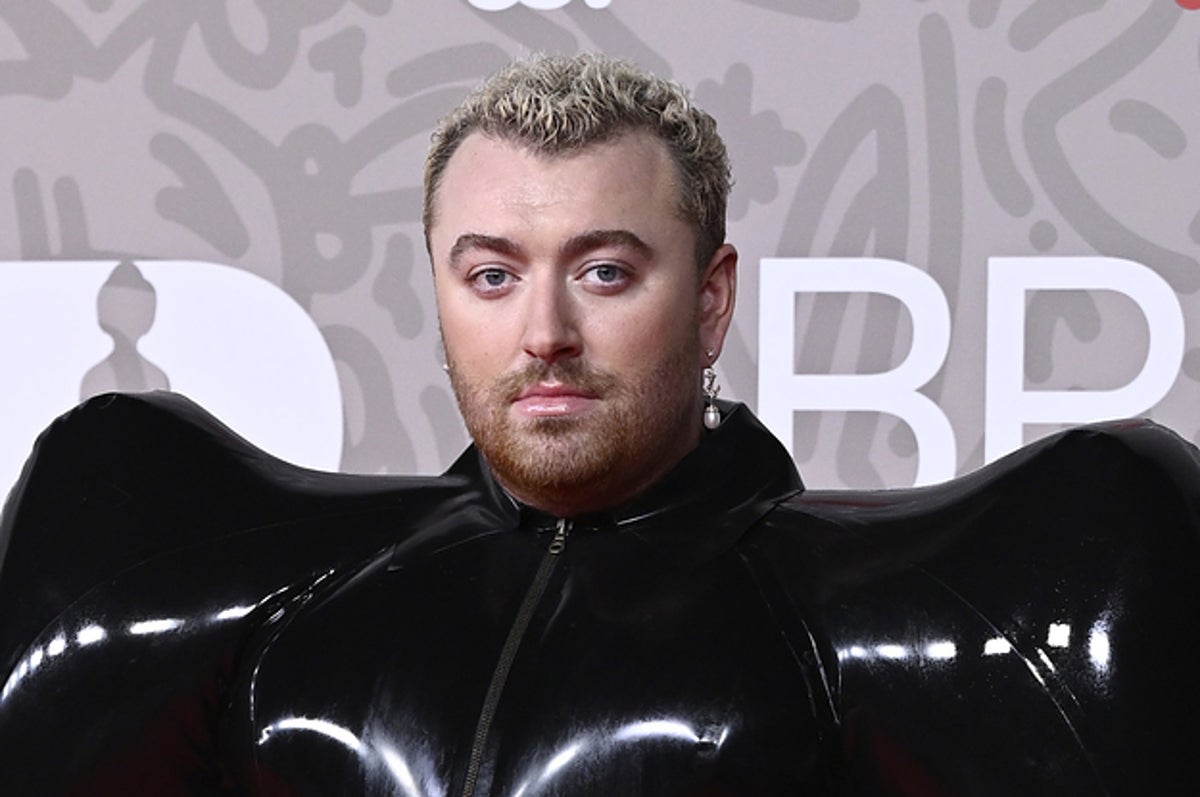 Sam Smith makes a bold fashion statement in a inflatable black latex  jumpsuit at the BRIT Awards