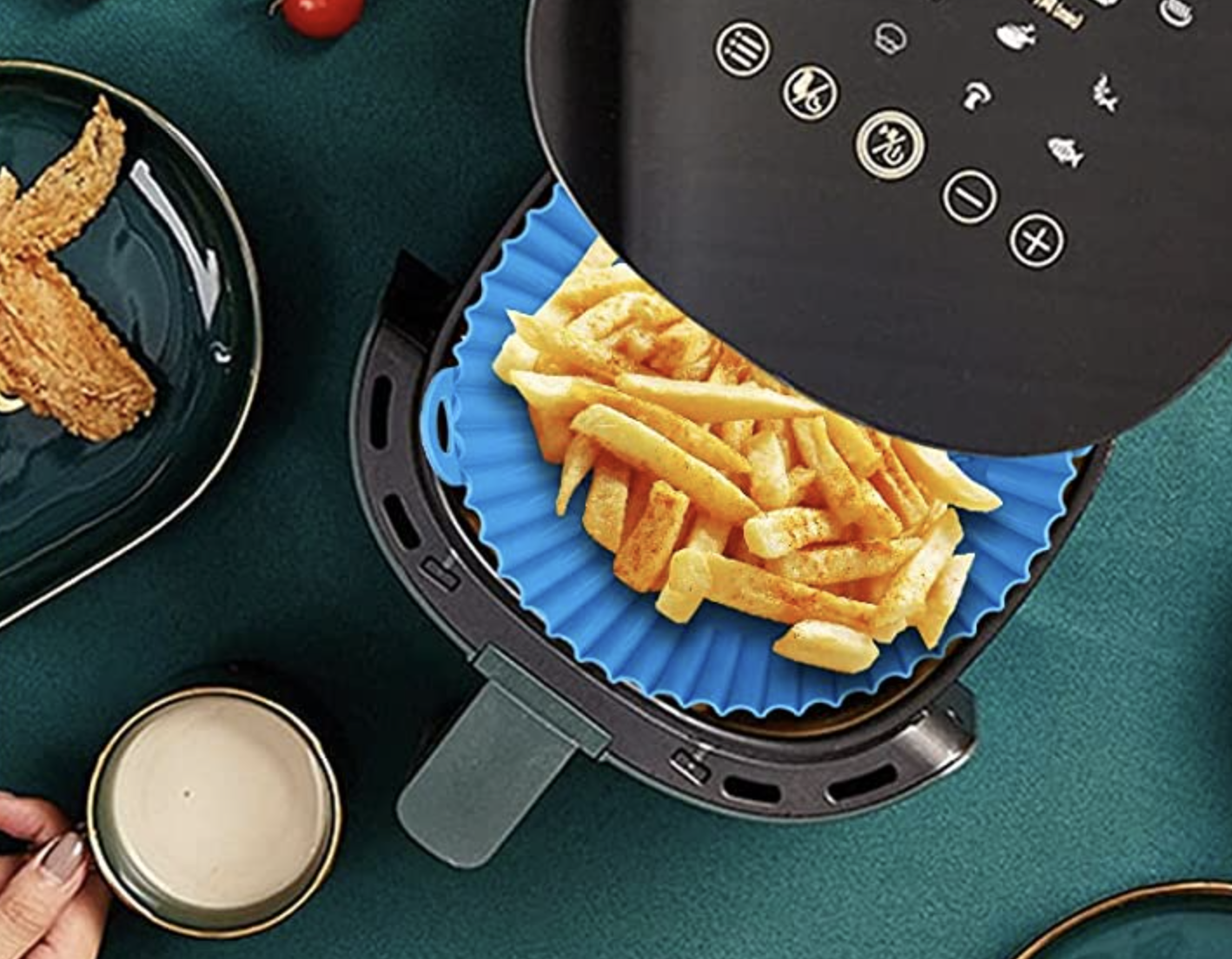 the liner in an air fryer holding a bunch of fries