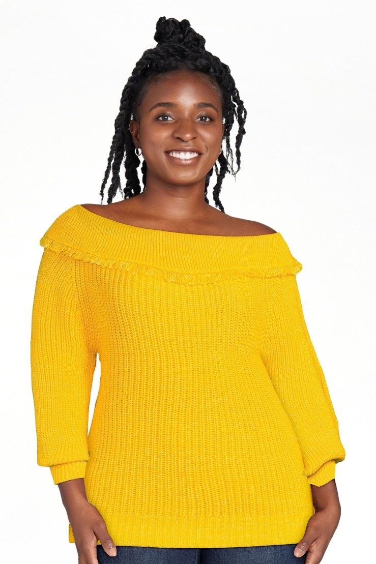 Model wearing a yellow sweater with jeans