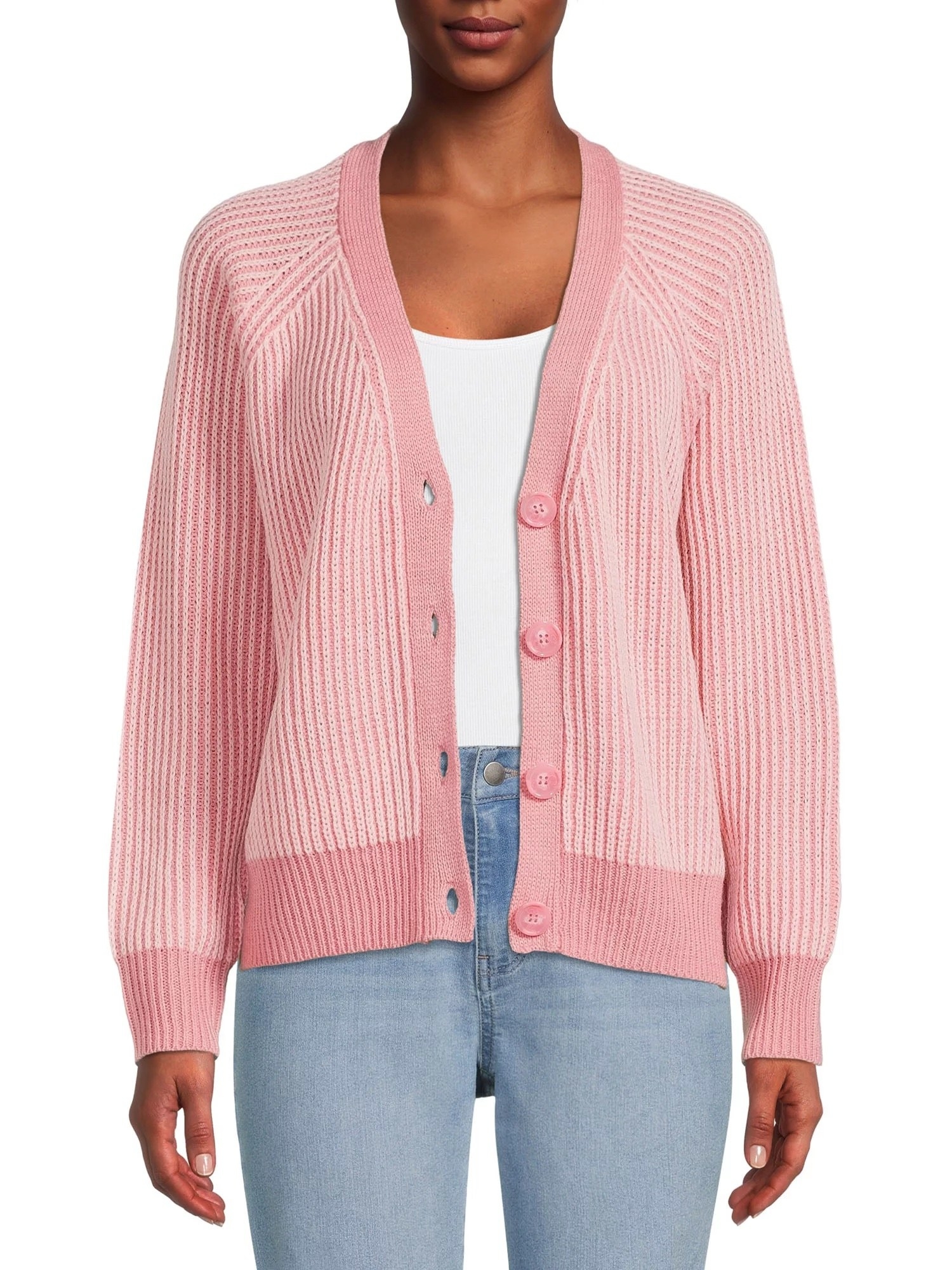 Model wearing pink cardigan over white tee and jeans