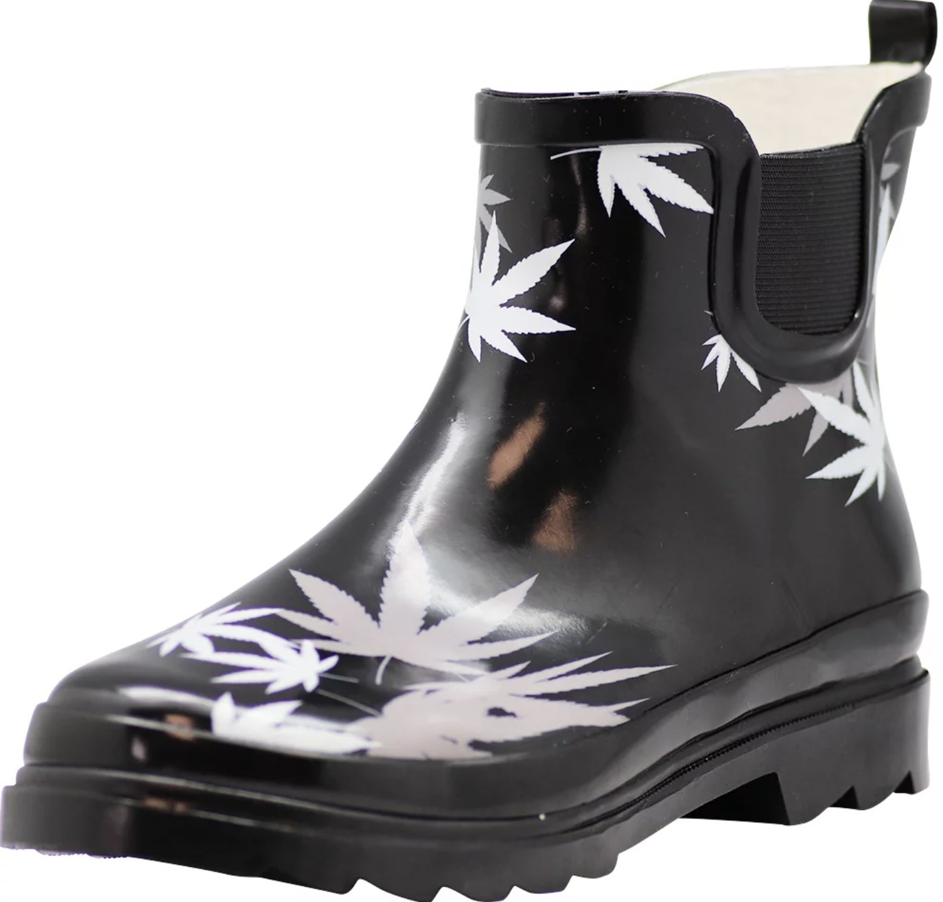 A black rain boot with white weed leaves on it