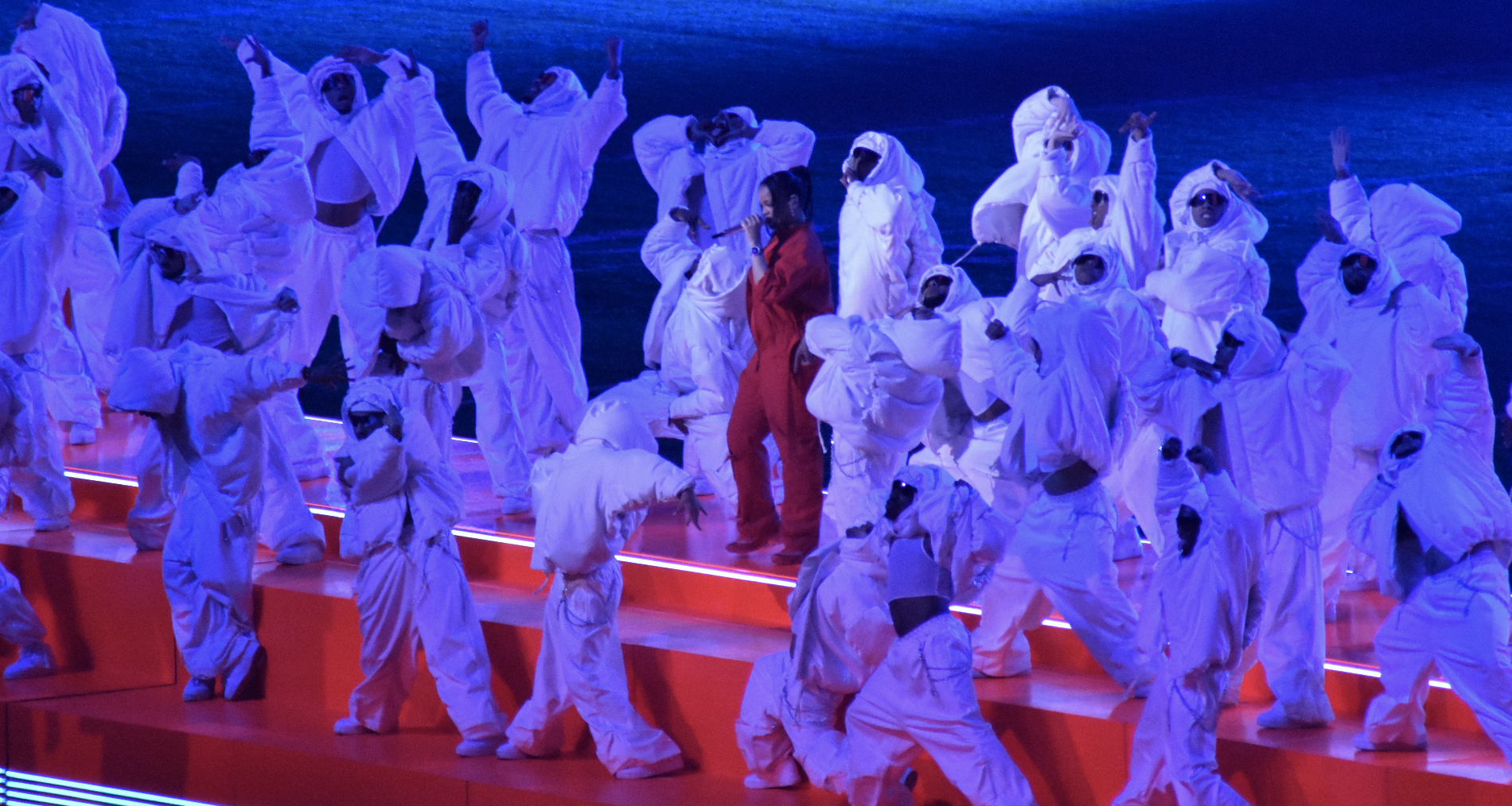 Rihanna and her dancers perform on a red stage