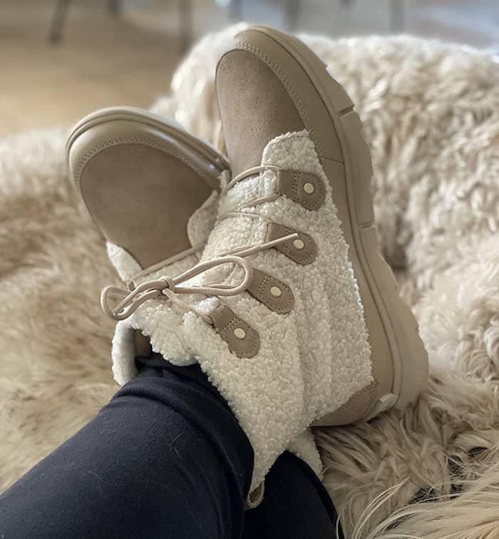 a reviewer photo of the cream colored boots