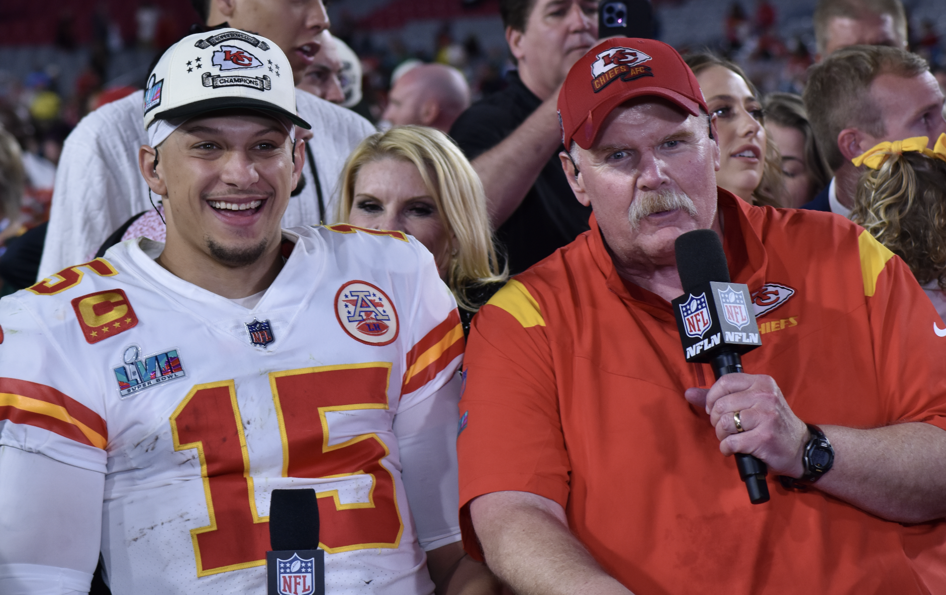 Patrick Mahomes and Andy Reid smile on the field after their Super Bowl win