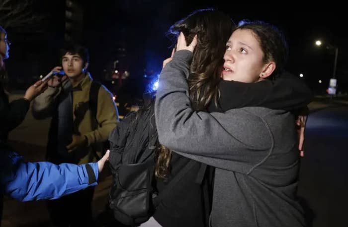 college students embrace outside at night