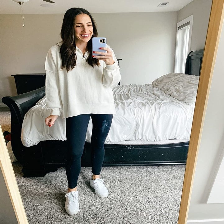 Reviewer wearing white sweatshirt and leggings