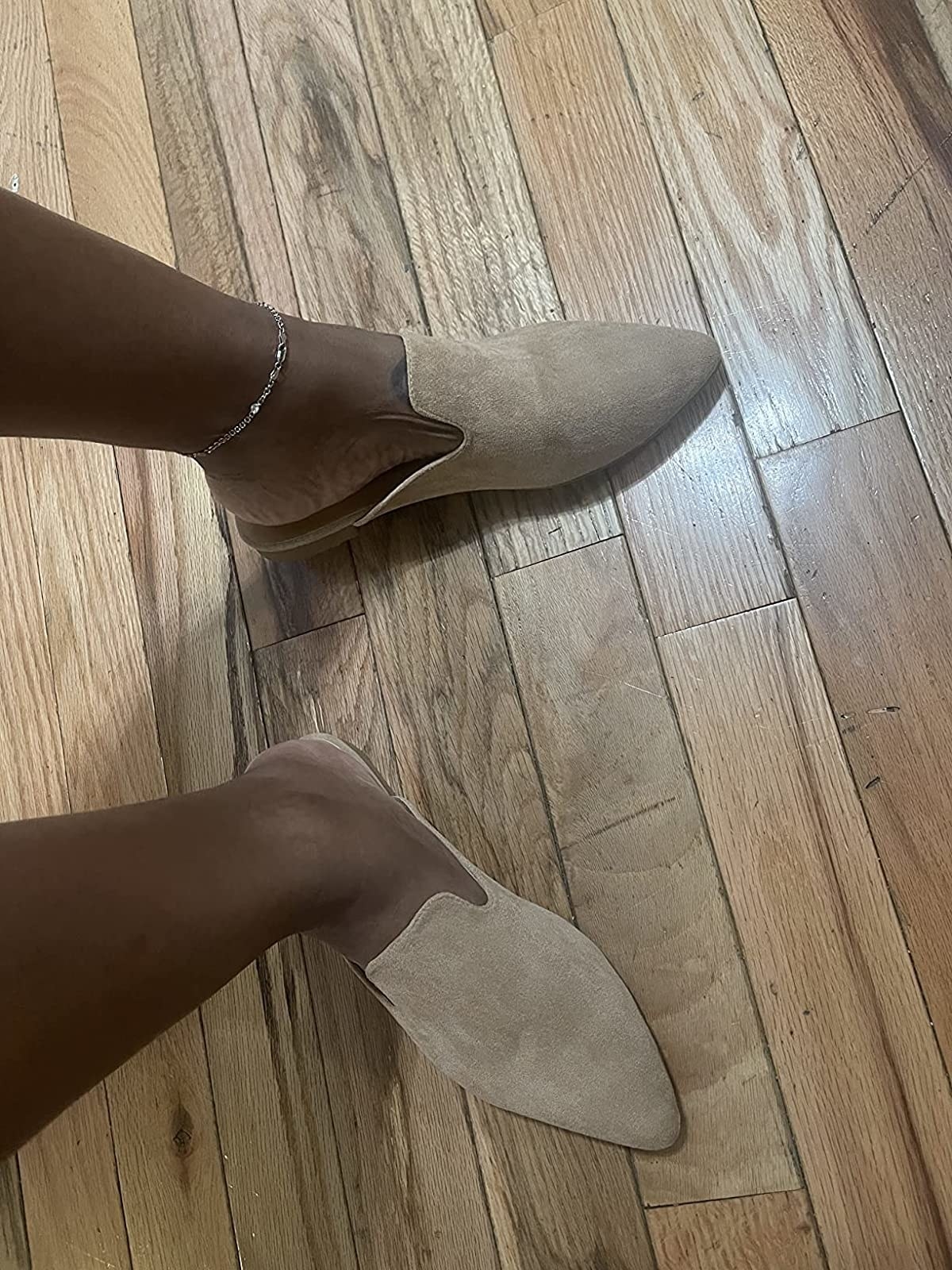 Reviewer wearing suede mules