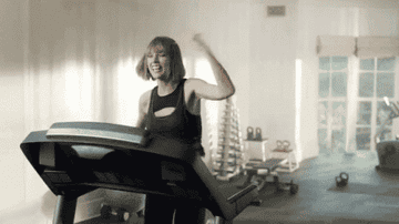 Taylor Swift listening to music and biting it on the treadmill