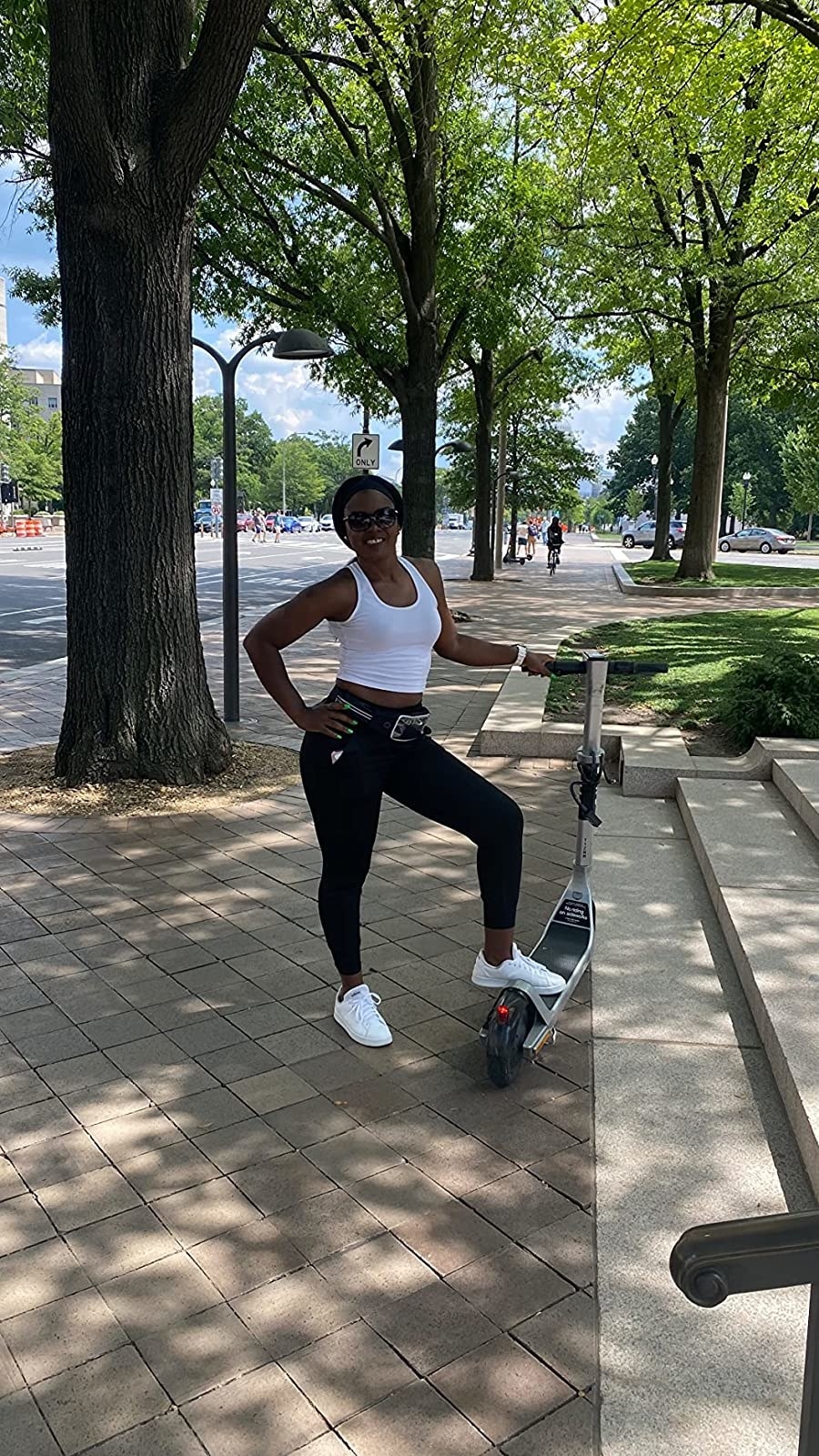 Reviewer wearing the white cropped tank and black jeans