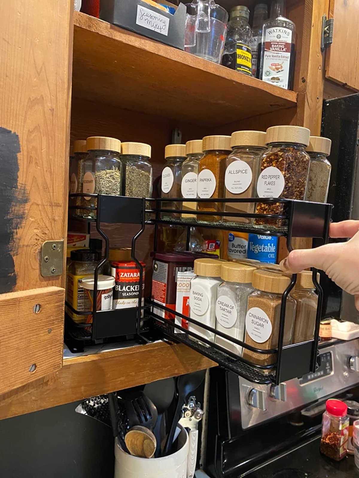 Reviewer pulling out spice rack