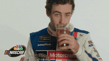 A NASCAR driver drinking a glass of sweet tea