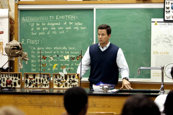 A man teaches at the front of a classroom
