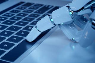A robot finger pressing a keyboard