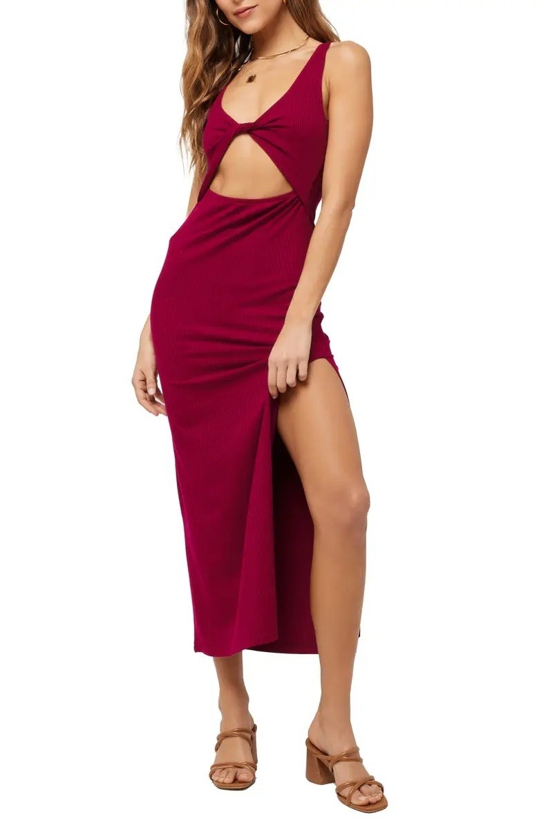model wearing red sleeveless cutout rib dress with side slit design and brown heeled sandals