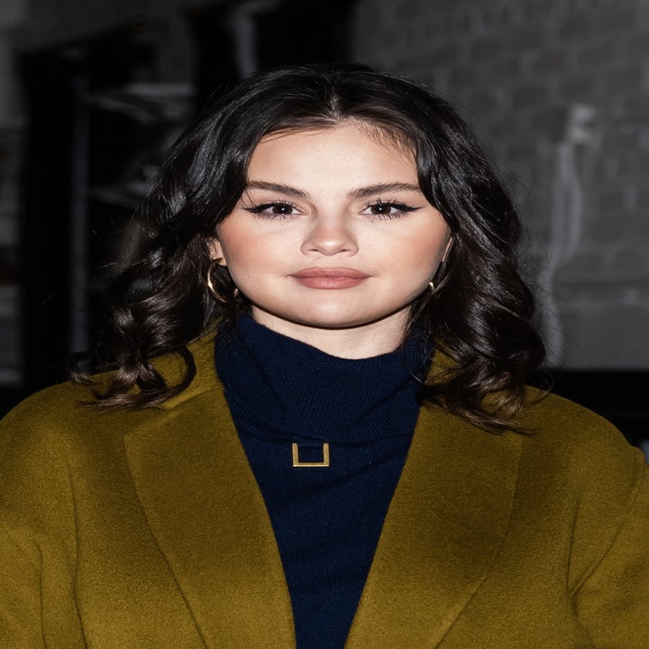 A closeup of Selena in a turtleneck and coat