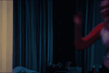 A lady jumps out and scares a boy