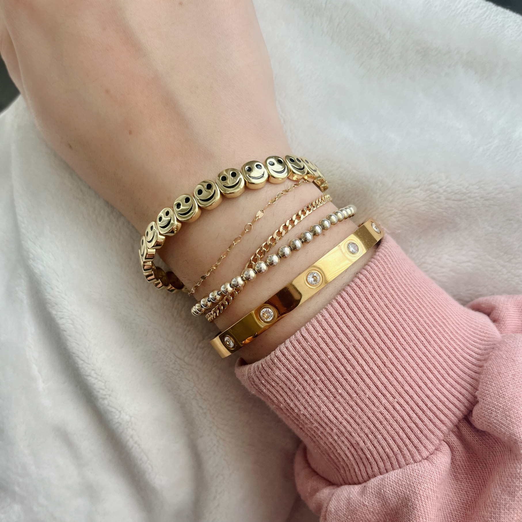 the bracelet on Melina&#x27;s wrist with other bracelets