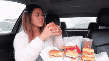 A woman eating food in her car