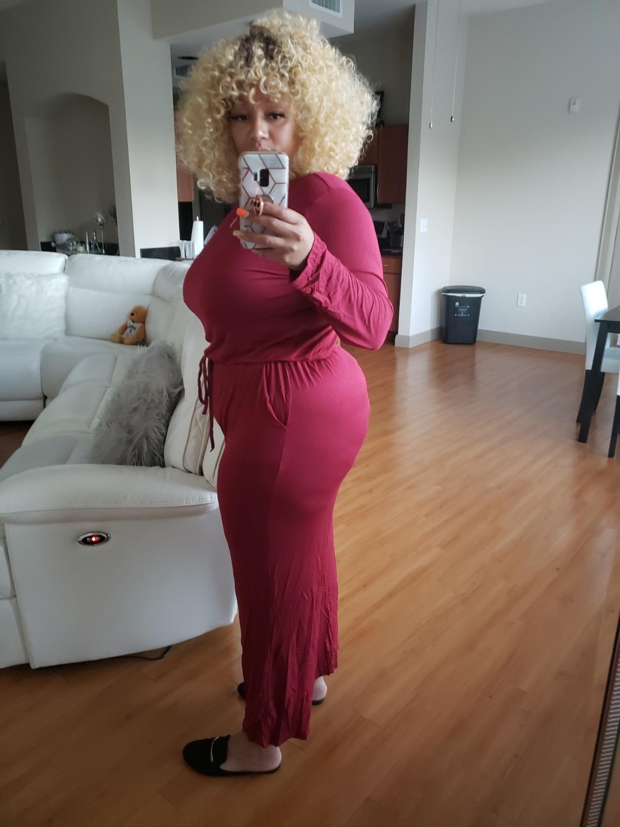 reviewer wearing the jumpsuit in a pink color