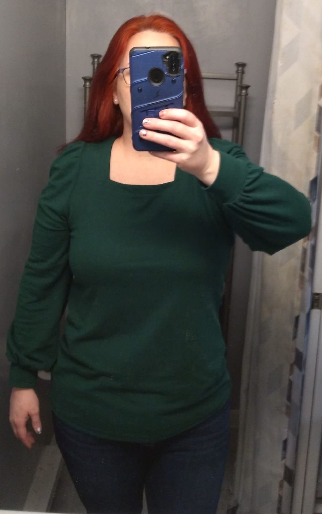 reviewer wearing green square neck top with jeans