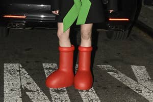 A guest is seen wearing a black and green jacket, white top, red beret and red boots outside the Collina Strada show during New York Fashion Week on February 10, 2023 in New York City.