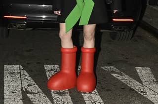 A guest is seen wearing a black and green jacket, white top, red beret and red boots outside the Collina Strada show during New York Fashion Week on February 10, 2023 in New York City.