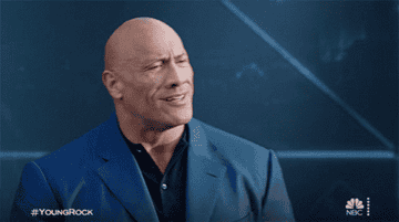 The Rock nodding and patting his chest