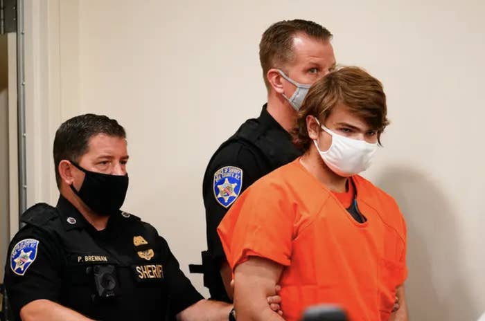 The teenage Buffalo shooter in an orange prison jumpsuit is escorted by two officers into his sentencing