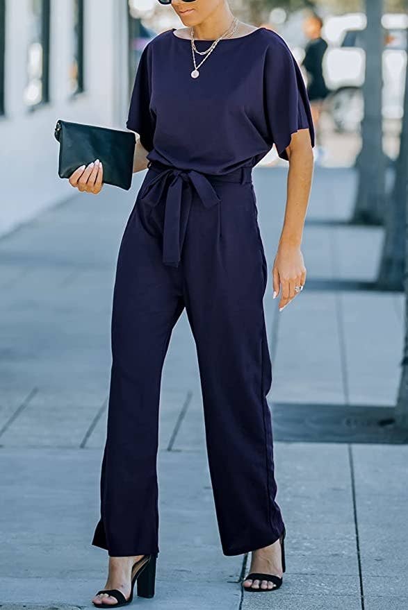 person walking on the street with the jumpsuit and heels