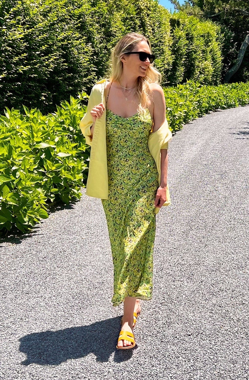 model wearing green floral slip dress